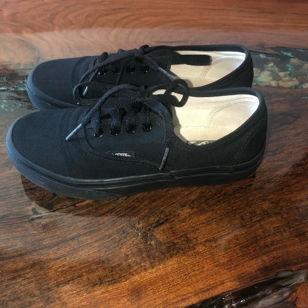 Vans all black kids lace up skateboard shoes.